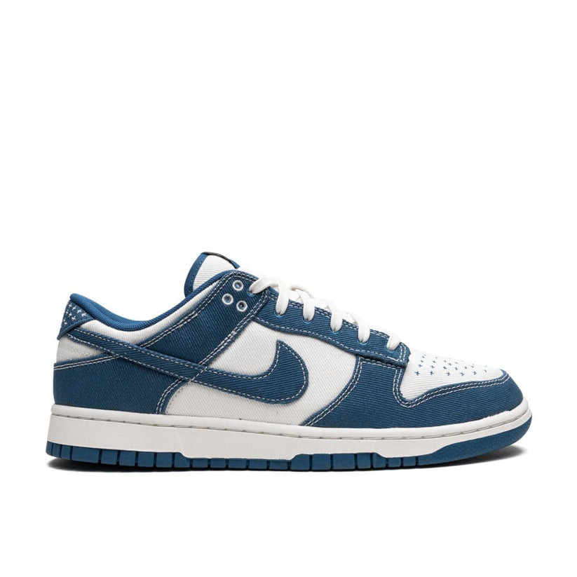 "Nike Dunk Low Sashiko Industrial Blue sneaker with textile twill upper and sashiko embroidery"

"Side view of Nike Dunk Low Industrial Blue with blue overlays and white midsole"

"Close-up of Nike Dunk Low Sashiko showing embroidered toe box and heel tab details"

"Nike Dunk Low Sashiko Industrial Blue – Japanese-inspired textile sneaker with denim overlays"