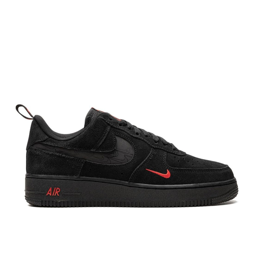 "Nike Air Force 1 '07 LV8 Black Light Crimson sneaker with black suede upper and reflective cut-out Swoosh"

"Side view of Nike Air Force 1 '07 LV8 Black Light Crimson with braided laces and crimson accents"

"Close-up of Nike Air Force 1 '07 LV8 Black Light Crimson showing perforated toe box and Nike Air heel branding"

"Nike Air Force 1 '07 LV8 Black Light Crimson – sleek black sneaker with subtle crimson highlights"