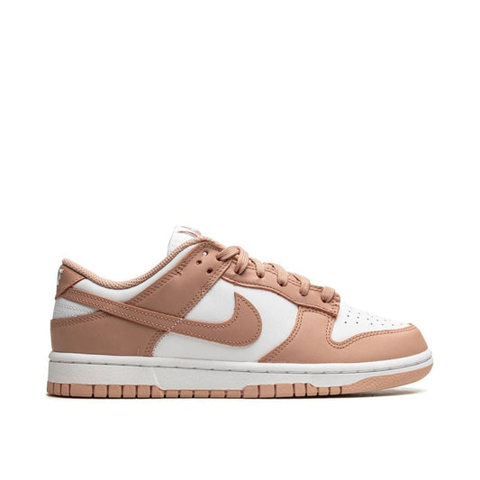 "Nike Dunk Low Rose Whisper sneaker with white leather base and rose pink overlays"

"Side view of Nike Dunk Low Rose Whisper with perforated toe box and pink rubber outsole"

"Close-up of Nike Dunk Low Rose Whisper showing soft pink Swoosh and white midsole"

"Nike Dunk Low Rose Whisper – feminine and versatile sneaker for women"