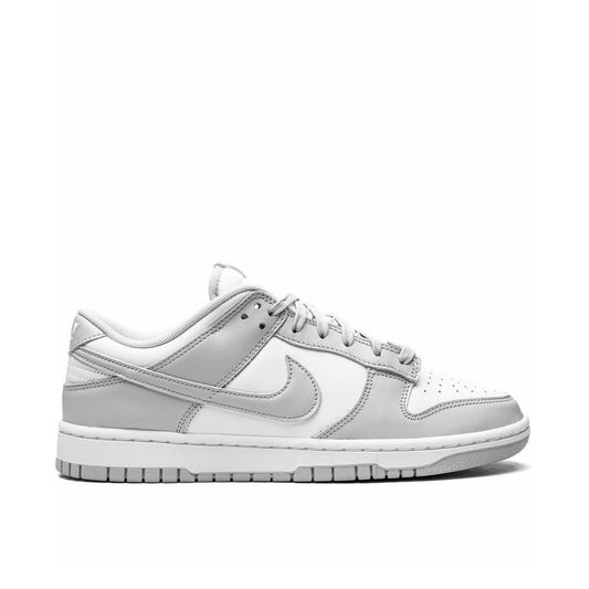 "Nike Dunk Low Grey Fog sneaker with white leather base and grey overlays"

"Side view of Nike Dunk Low Grey Fog with white mesh tongue and grey laces"

"Close-up of Nike Dunk Low Grey Fog showing grey Swoosh and white midsole"

"Nike Dunk Low Grey Fog – versatile low-top sneaker with clean neutral colorway"